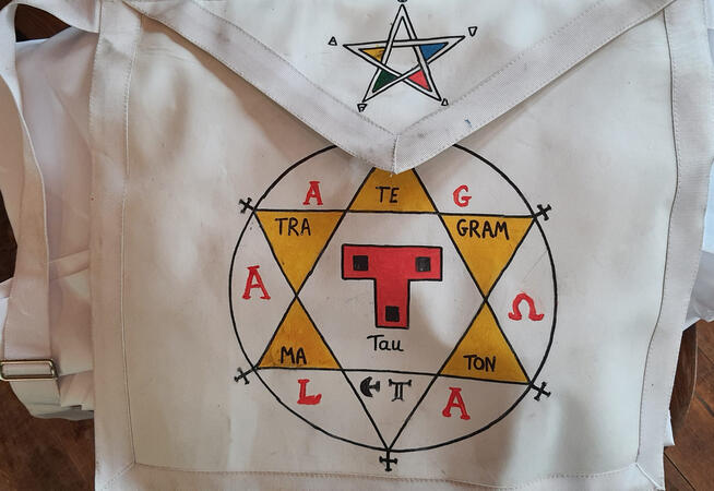 White ceremonial apron painted with a Tau cross and hexagram White ceremonial apron painted with a Tau cross and hexagram