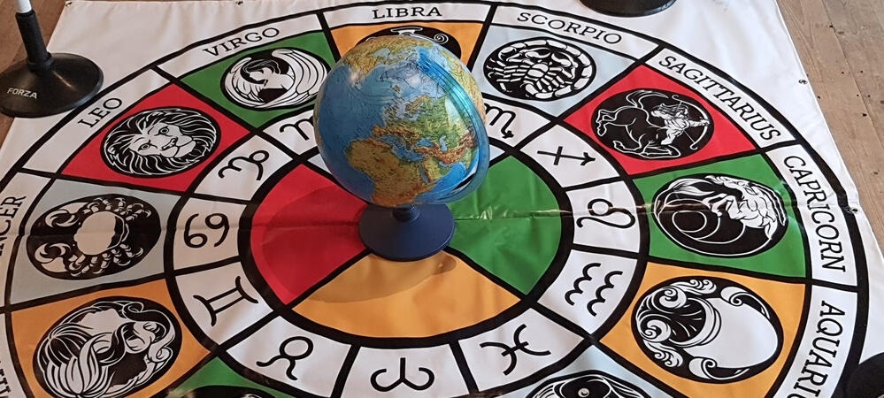 Globe centred on a colourful zodiac circle Globe centred on a colourful zodiac circle